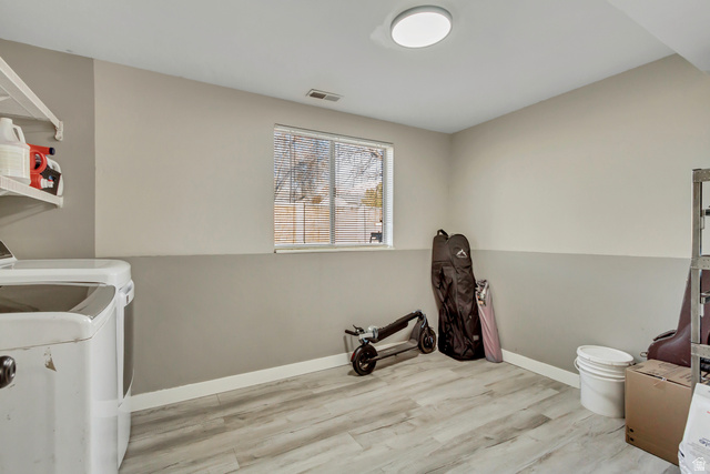 933 South Freedom Boulevard, Unit 7 Provo, UT 84601 - Photo 16 of 23 Large storage and Laundry room with LVP wood-style floors and washer and dryer