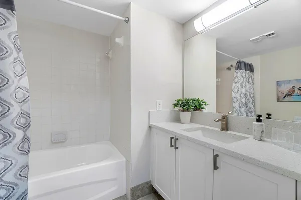 a bathroom with a bathtub shower sink and toilet