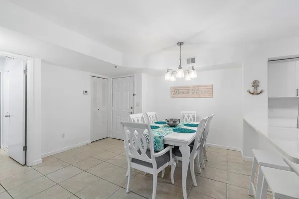 a view of a dining room with furniture wooden floor and chandelier