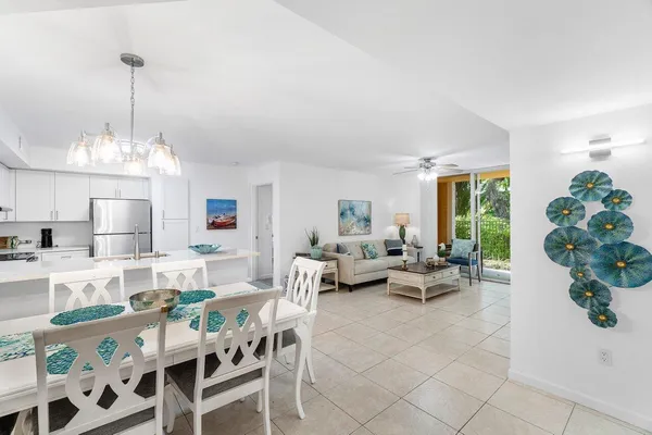 a living room with furniture and view of kitchen