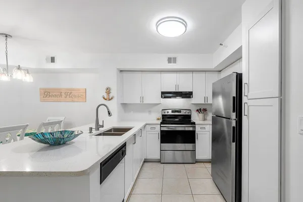 a white refrigerator freezer and a stove top oven
