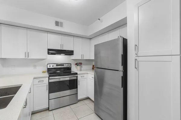 a kitchen with a sink stove and cabinets