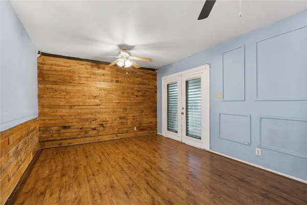 wooden floor in an empty room with a window