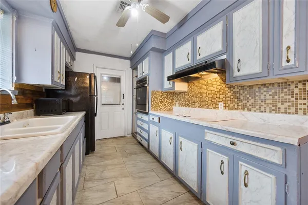 a kitchen with granite countertop a sink and cabinets