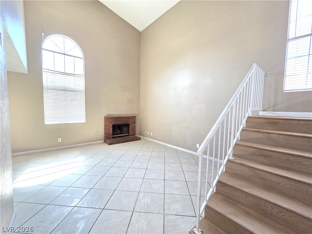 2882 Sandyfalls Way Las Vegas, NV 89142 - Photo 2 of 18 A spacious living area featuring soaring vaulted ceilings and a classic corner fireplace.