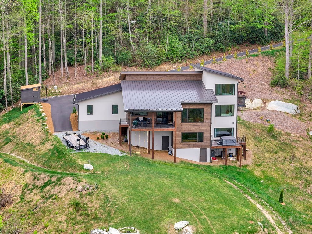 799 Milton Brown Heirs Road Boone, NC 28607 - Photo 47 of 49 a view of a house with a yard and sitting area