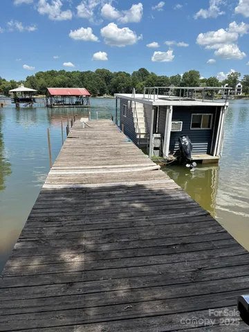 a view of a lake with boats and trees in the background