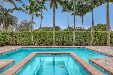 a view of a house with swimming pool and a porch