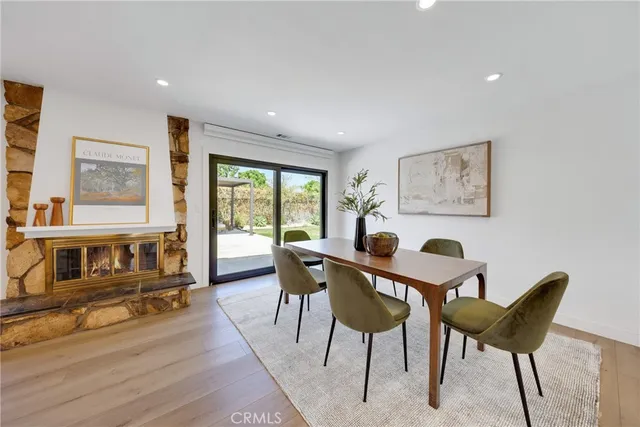 a living room with furniture a flat screen tv and a large window