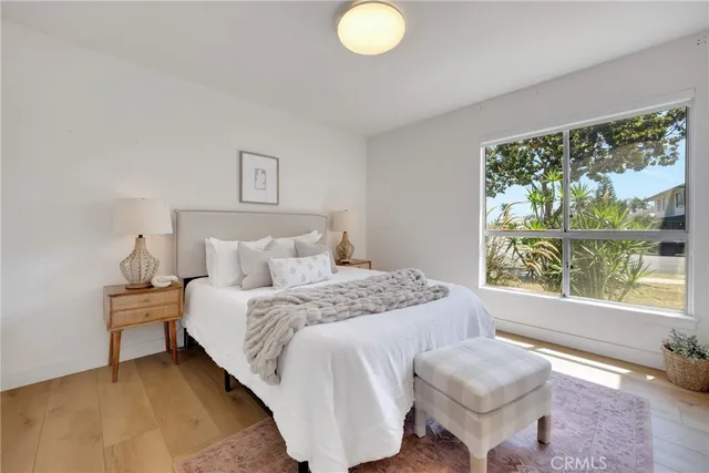 a bedroom with a bed and a large window