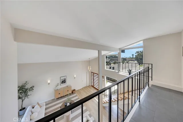 a view of a hallway with wooden floor and stairs