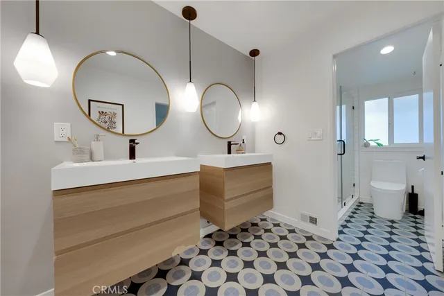 a bathroom with a sink mirror and toilet