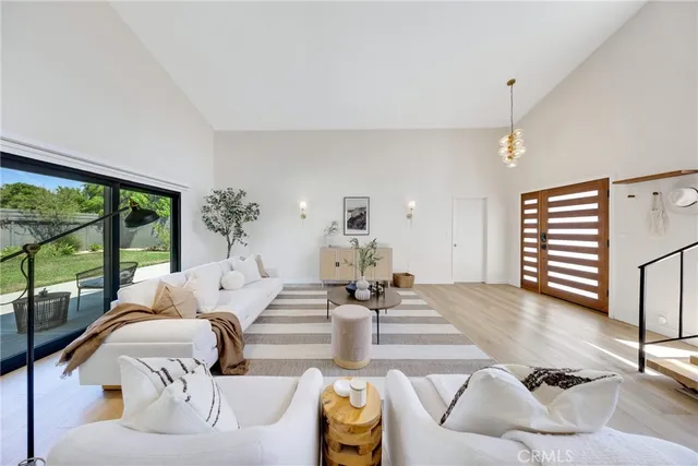 a living room with furniture flowerpot and a large window