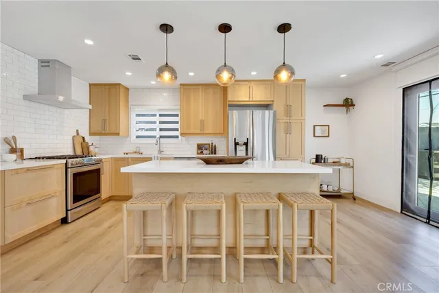 a kitchen with cabinets a sink and appliances