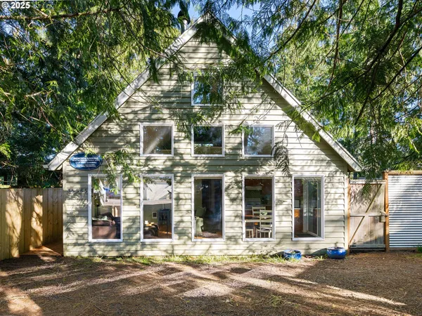 front view of a house with a tree