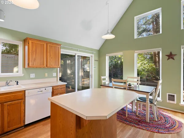 a kitchen with a stove a sink a table and chairs