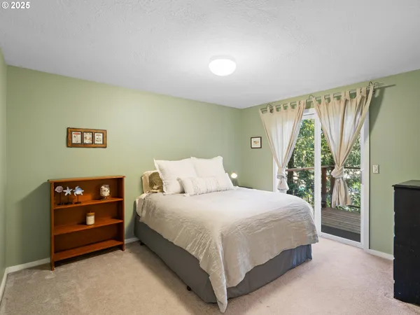 a bedroom with a bed and a night stand