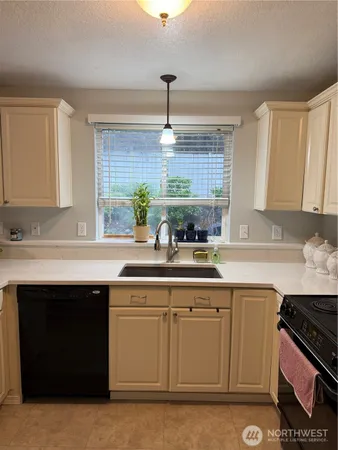 a kitchen with a sink stove and cabinets