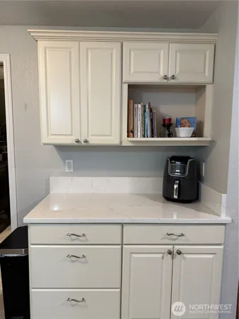 a stove top oven sitting inside of a kitchen