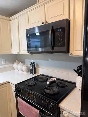a stove top oven sitting inside of a kitchen