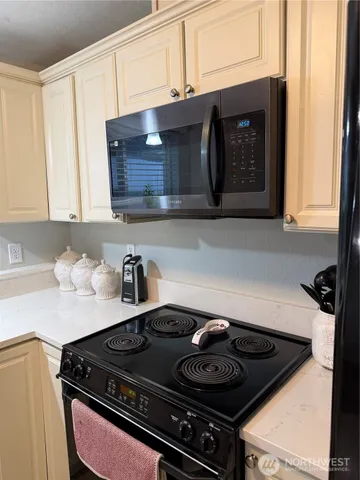 a stove top oven sitting inside of a kitchen