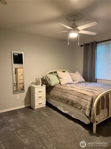a spacious bedroom with a bed and a cabinets