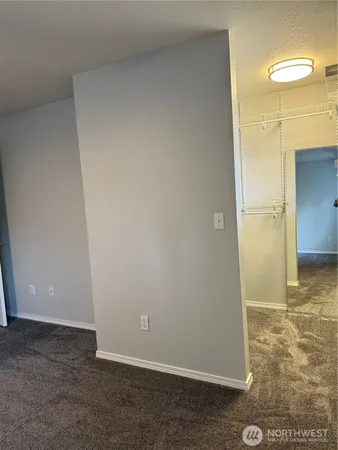 a view of a house with a barbeque and wooden fence
