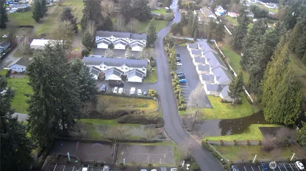 an aerial view of a house with yard