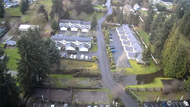 an aerial view of a house with yard
