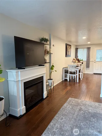 a living room with furniture a fireplace and a flat screen tv