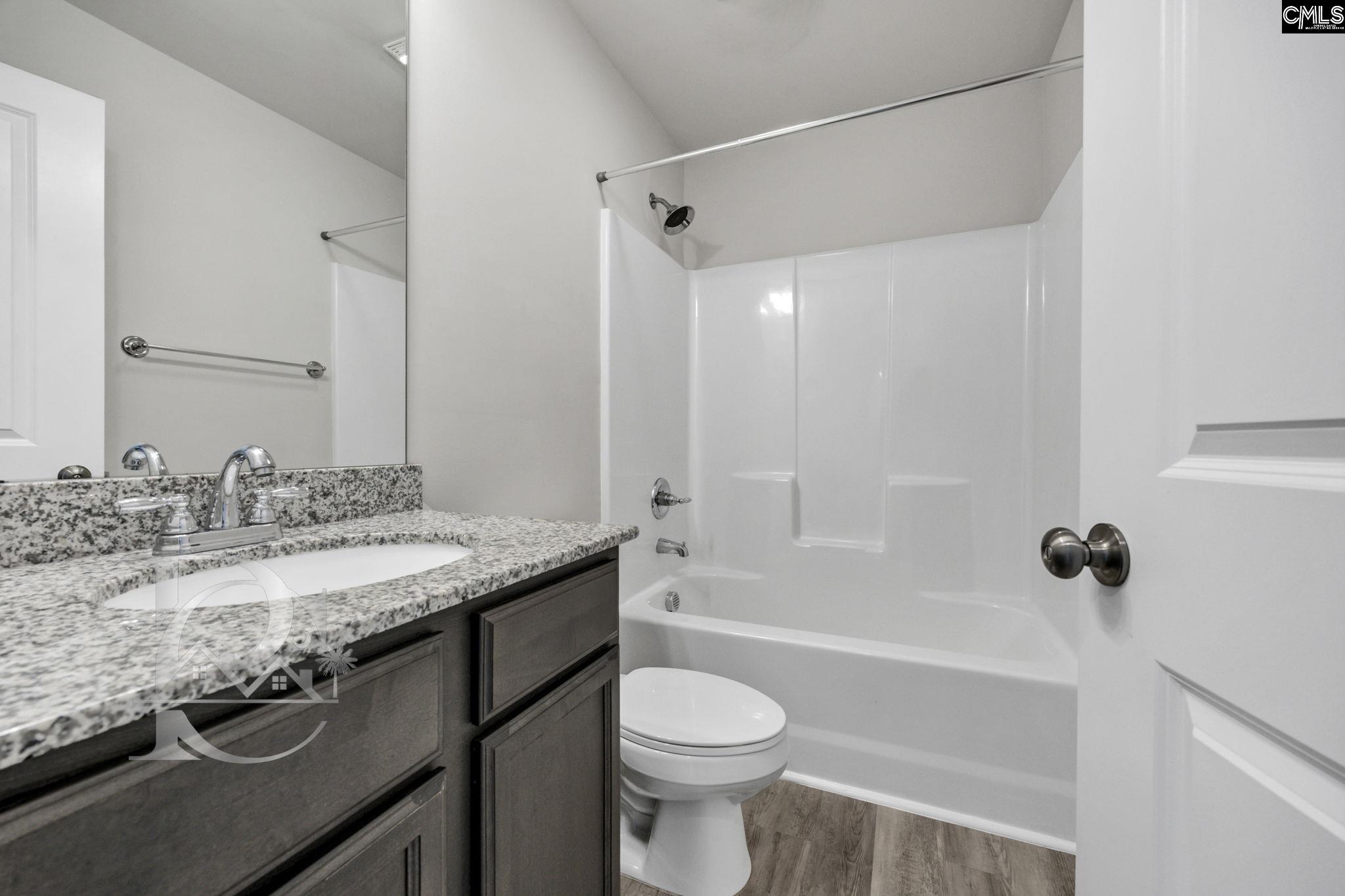 235 Drayton Hall Road West Columbia, SC 29172 - Photo 23 of 24 a bathroom with a granite countertop sink toilet and shower