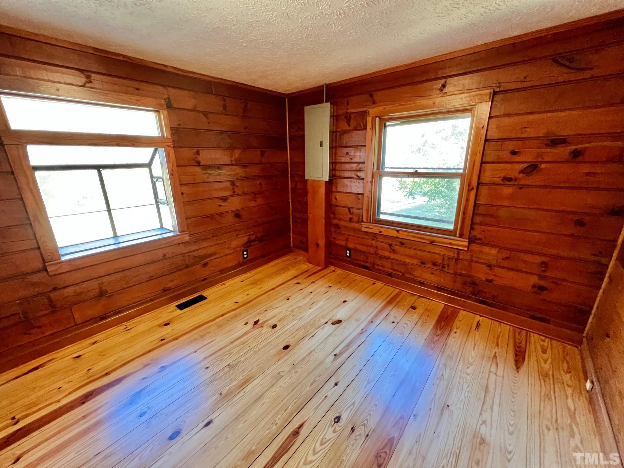 110 Keyser Lane Roxboro, NC 27574 - Photo 34 of 62 a view of empty room with wooden floor and fan