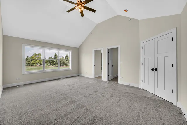 a view of a livingroom with a ceiling fan and window