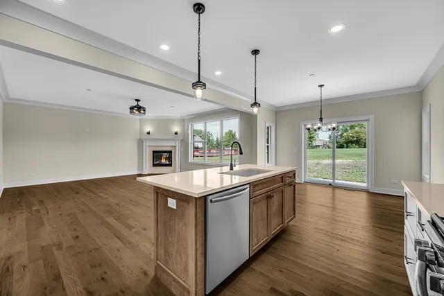 a kitchen with kitchen island a sink and a stove top oven