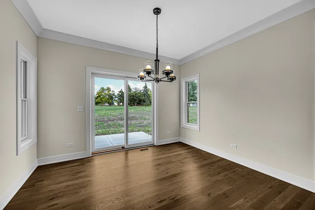a view of a room with wooden floor fireplace and a window