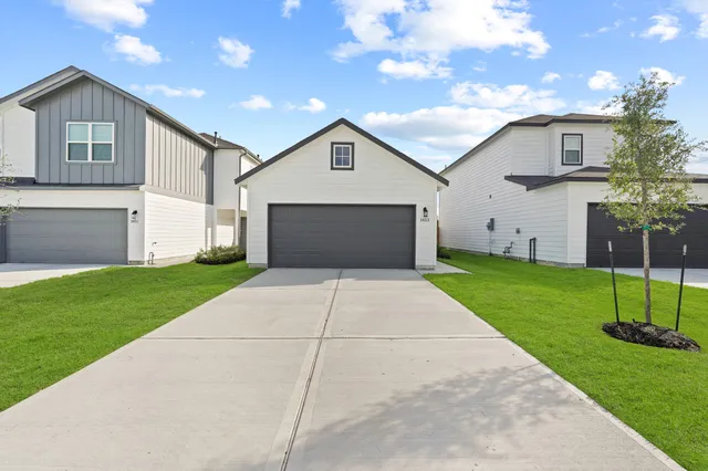 a front view of house with yard and green space