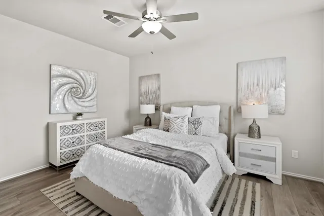 a bedroom with a bed and a night stand