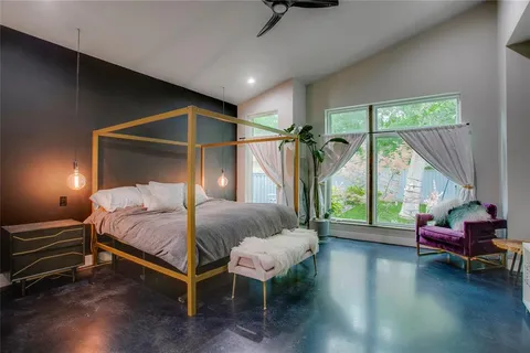 a bedroom with a bed window and a table