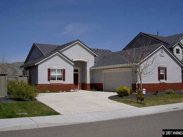 1621 Dutch Ravine Court Reno, NV 89521 - Photo 1 of 9 a front view of a house with a yard and garage