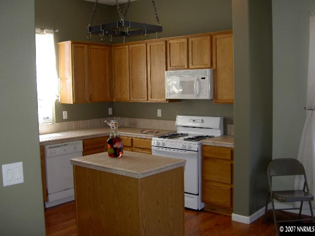 1621 Dutch Ravine Court Reno, NV 89521 - Photo 2 of 9 a kitchen with a stove a sink and a microwave