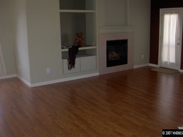 1621 Dutch Ravine Court Reno, NV 89521 - Photo 4 of 9 a view of a livingroom with wooden floor and a fireplace