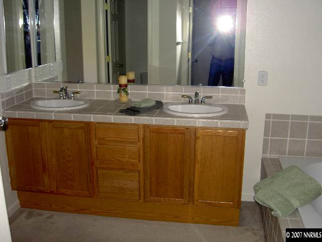 1621 Dutch Ravine Court Reno, NV 89521 - Photo 7 of 9 a bathroom with a granite countertop sink and a mirror