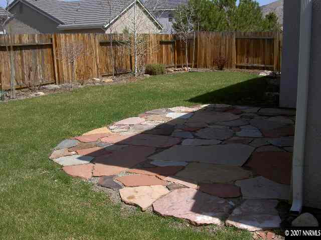 1621 Dutch Ravine Court Reno, NV 89521 - Photo 9 of 9 a backyard of a house with lots of green space