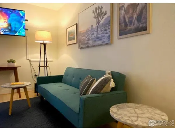 a living room with furniture and a lamp