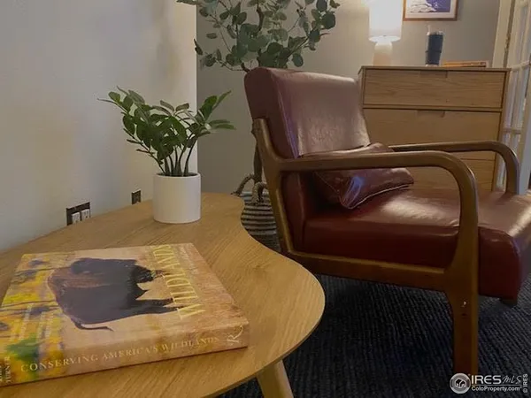 a blue vase with flowers sitting on a table