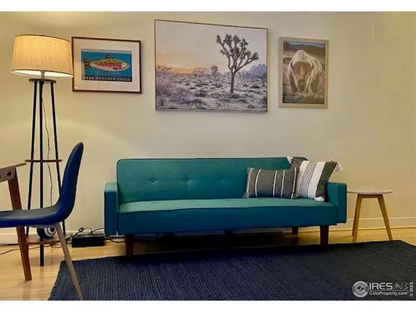 a living room with furniture and a lamp