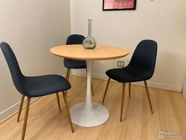 a table with chairs and a potted plant