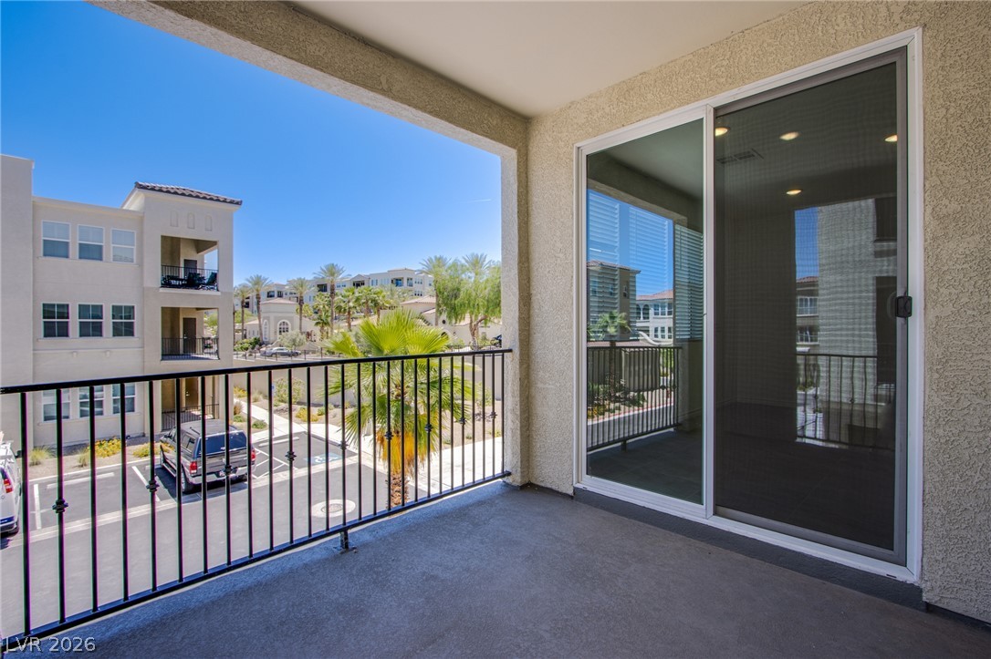 Sliding glass doors open onto a private covered balcony overlooking the surrounding neighborhood.