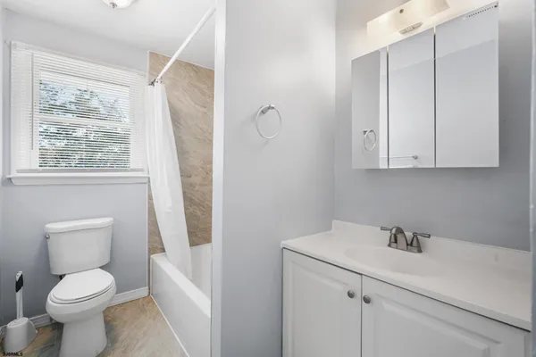 a white toilet sitting next to a bathroom sink