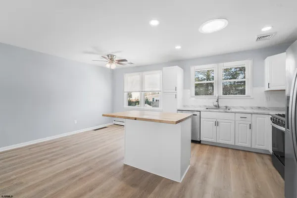 a kitchen with a sink cabinets and window
